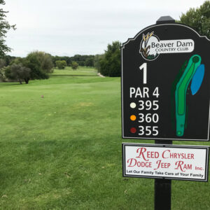 sign shown with local advertising on golf course